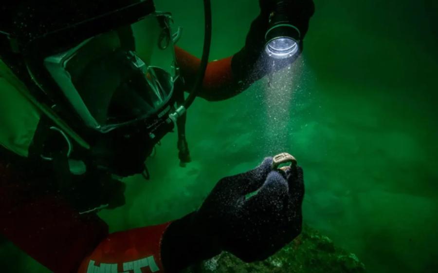 The Lighthouse of Alexandria ring at the time it was found held by underwater archaeologist.