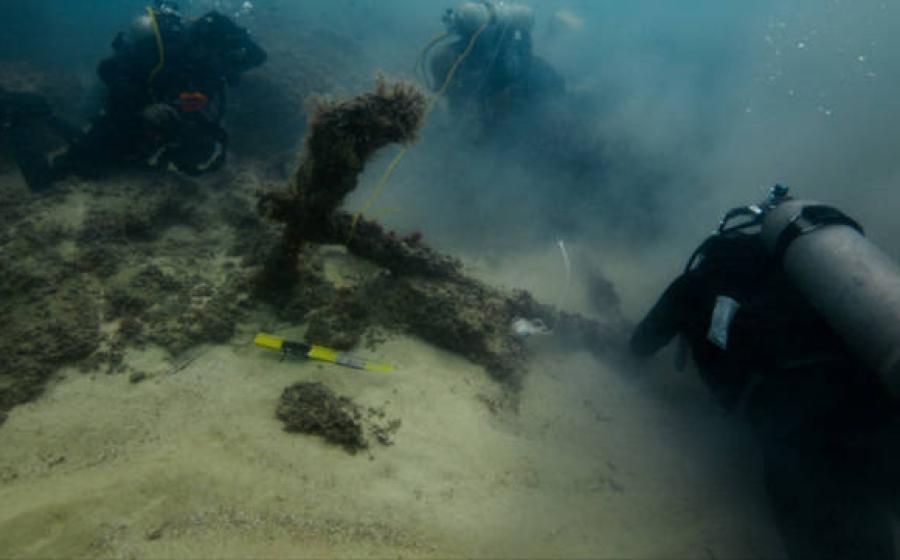 Divers exploring the submerged ancient structures off the coast of Taposiris Magna 