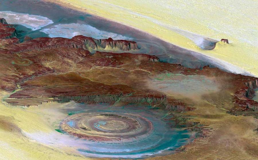 A topographic reconstruction from satellite photos of the Richat Structure with false coloring. False coloring as follows: Brown: bedrock; Yellow/white: sand; Green: vegetation; Blue: salty sediments. Source: NASA/JPL/NIMA / Public domain