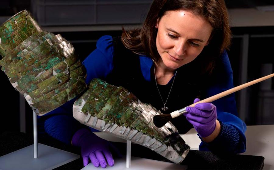 Conservator Bethan Bryan with the Roman arm guard. Source: Duncan McGlynn / National Museums Scotland