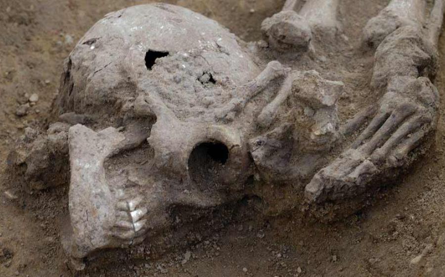 This photo shows one particular body where the head has been lopped off and placed at the feet of the victim found at the Roman burial site, Somersham, UK.  