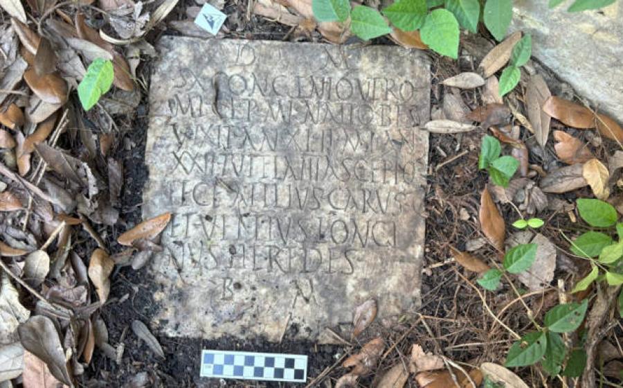 The Roman headstone before removal with its inscription visible.  