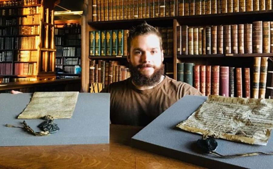 Dr. Benjamin Pohl with the both the royal charter and the Bishop of Durham charter 