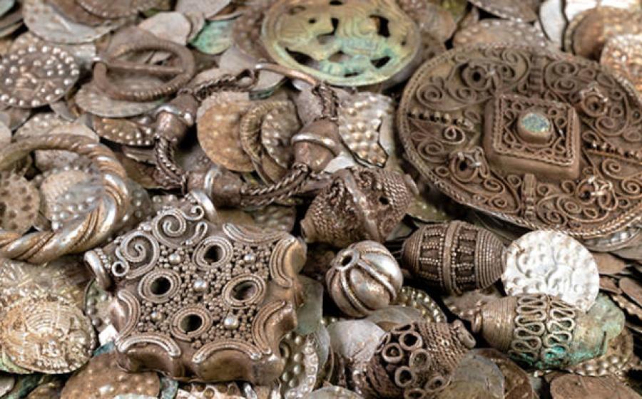 Selection of silver coins, jewelry, and pendants from the medieval hoard discovered near Stockholm.