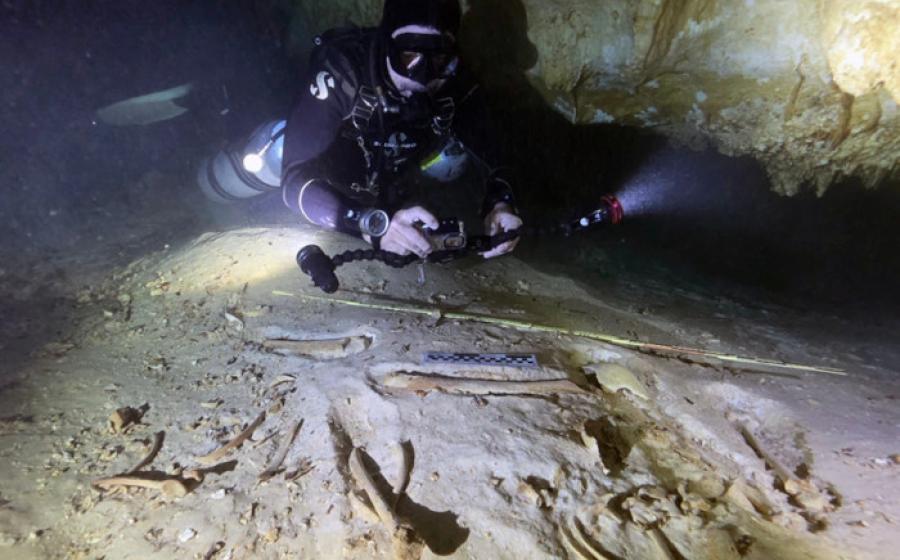 Underwater archaeologist Octavio del Río photographs the prehistoric skeleton discovered inside the flooded cave system in Actun, near Tulum, Mexico