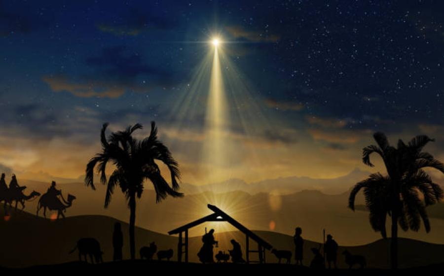 The Star of Bethlehem shining over the nativity stable scene.