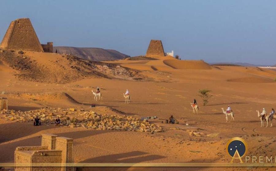 Locals on camels near Meroe pyramids, Sudan (Matyas Rehak/ Adobe Stock)