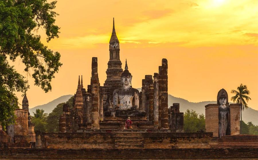 Ancient pagoda and big buddha at Sukhothai Historical Park, the birthplace of the Sukhothai Kingdom. Source: somrakjendee / Adobe Stock.
