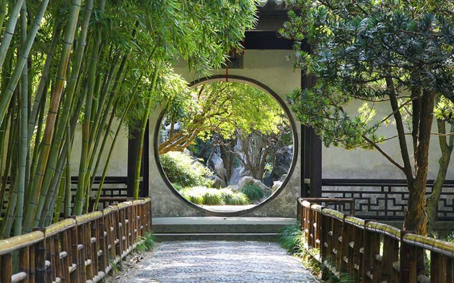 Circular gate in the Suzhou gardens. Source: rudiuk / Adobe Stock 