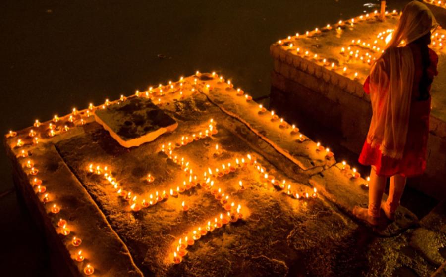 Swastika symbol decoration of clay lamps (diya) in Varanasi, India on the festival of Dev Diwali. Source: ShishirKumar / Adobe Stock