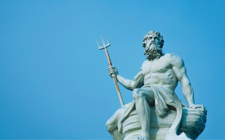 Ancient stone statue of mighty god of the sea and oceans Neptune (Poseidon) with trident.	