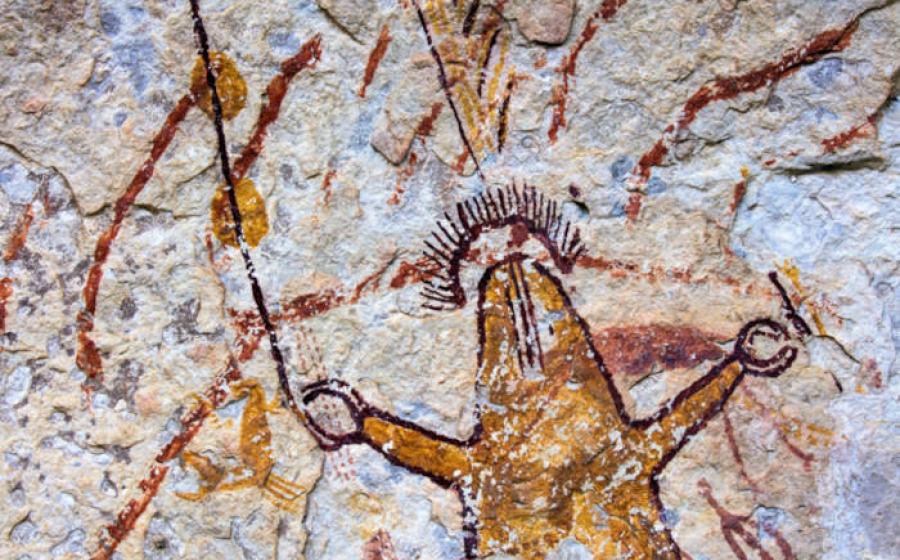 Ancient polychromatic Pecos River style rock art mural showing humanlike figures with elaborate symbolic elements.