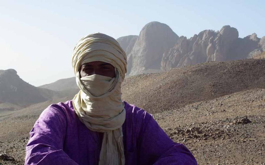Tuareg man with his traditional tagelmust face and head covering in the mountains of Hoggar, Algeria.	 Source: Sahara Nature / Adobe Stock 
