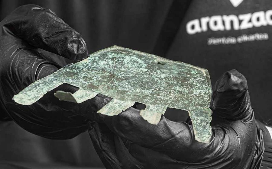 Researcher holding the bronze Irulegi hand inscribed in Vasconic script. Source: Aiestaran, M. et. al / Antiquity Publications Ltd