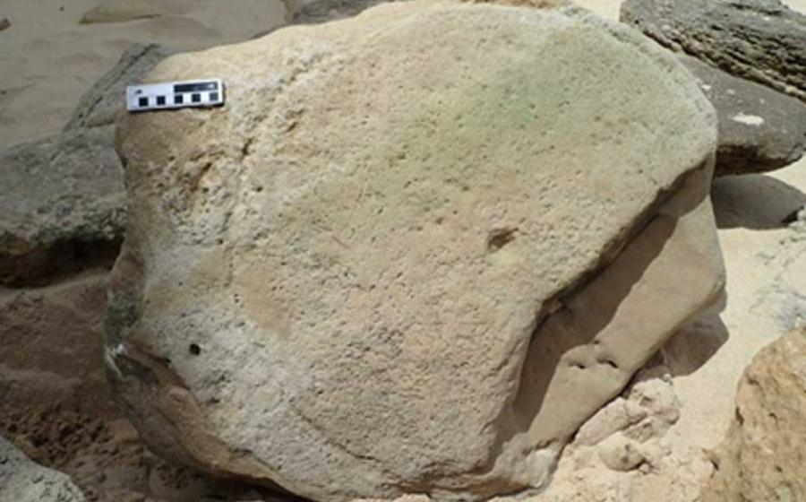 A rock surface containing a circular pattern with a central depression. Source: Science Direct.