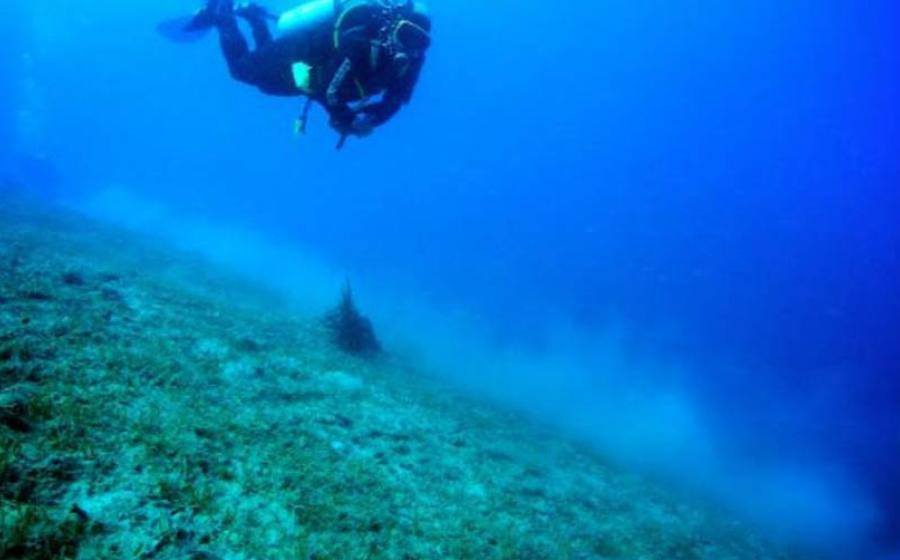 A diver works another ancient shipwreck off the coast of Italy, in 2012