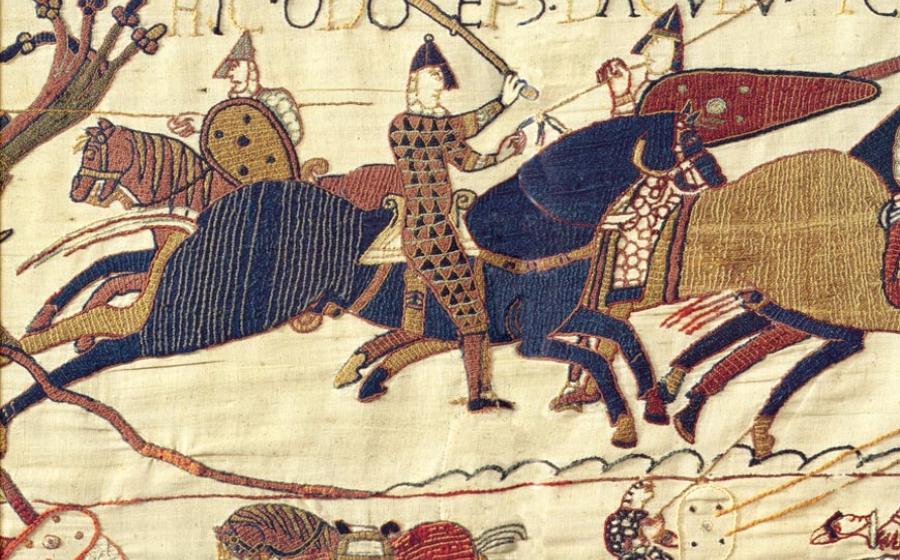 : A segment of the exquisite Bayeux Tapestry. In this scene Odo, Bishop of Bayeux (with raised club), half-brother to William the Great, rallies the troops in the Battle of Hastings in 1066.