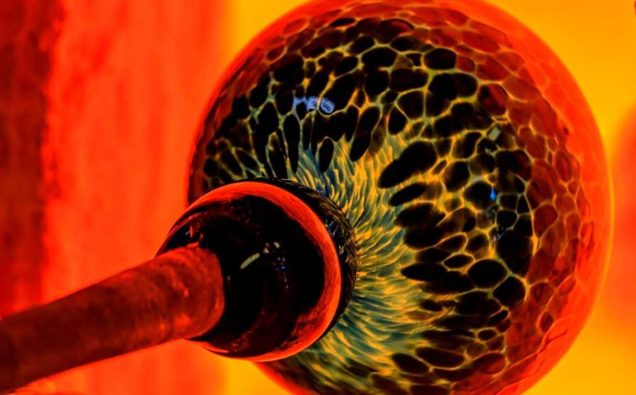 Glassblowing processs, with a ball of glass being heated by a kiln. Source: SvetlanaSF / Adobe Stock