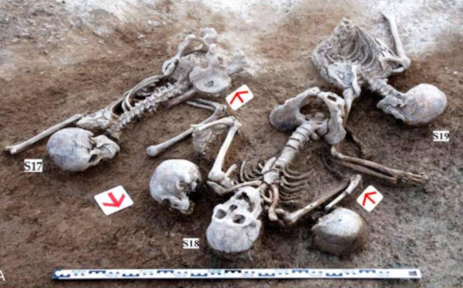 Battered skeletons plus extra unattached skulls excavated from site near Great Wall of China in 2009.