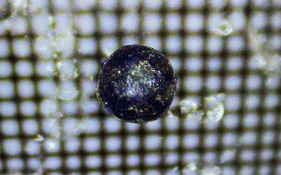 Images of one of the tiny metal fragments that came from a meter-size object that crashed off the coast of Papua, New Guinea in 2014.            Source: Avi Loeb/Medium