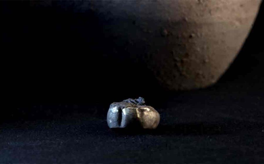 Archaeologists found a gold earring hidden inside a jar that had been placed in a wall at the Iron Age settlement called Tossal de Baltarga. 	Source: Marco Ansaloni/Frontiers