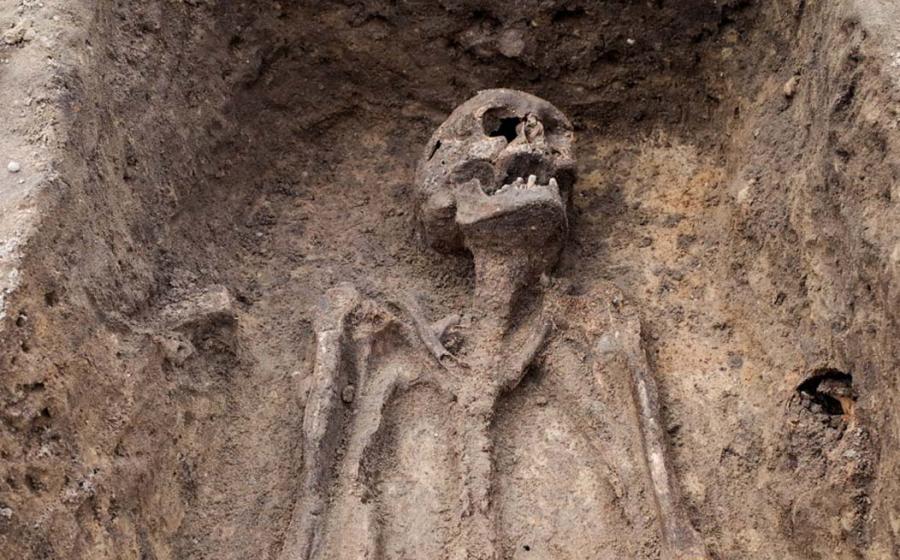 Archaeological excavation with skeleton, representational image only