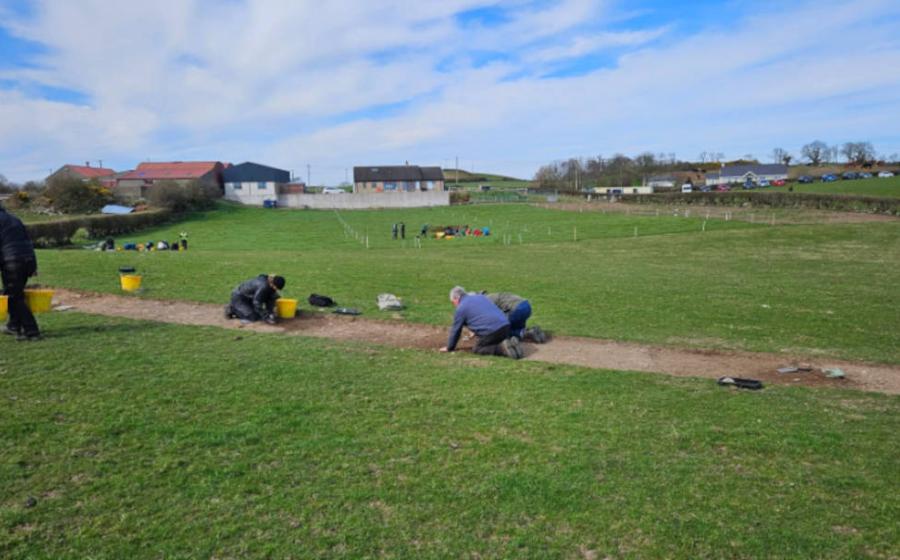 Teams of volunteers performing excavations in the rural area of Northern Ireland where the remains of the 12th century monastery have been found.