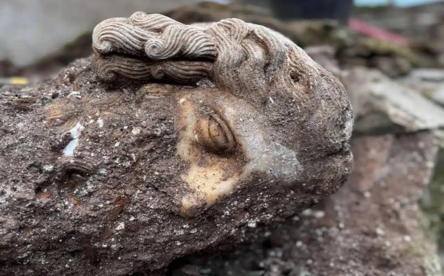The large, detached statue head, at the site where it was originally excavated in the Archaeological Park of the Appian Way.