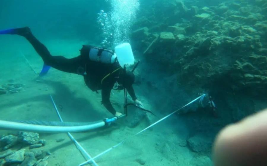 Underwater excavations occurring at site of port facilities submerged at site of ancient city of Asine.