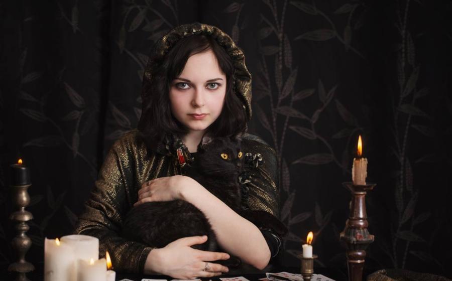 A witch with her cat familiar, a spirit servant to help her with magic.