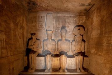 Sunlit statues in the inner sanctuary of the Great Temple at Abu Simbel.