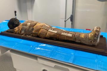 The 2,000-year-old Egyptian child mummy resting on a table before examination. 