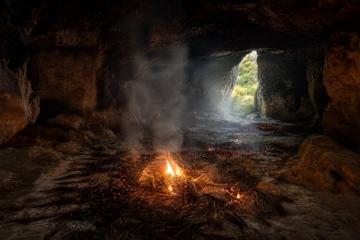 representations of Cloggs Cave Interior with grass burning on the cave floor.