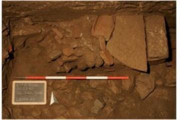  Excavation sequence showing the stone-and-brick cist grave of two newborn infants discovered inside a disused Roman latrine channel beneath the Odeion