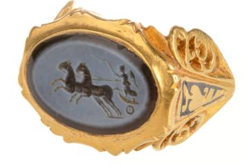 The Roman gold finger ring with a dark blue and light grey nicolo engraved gem depicting Victory
