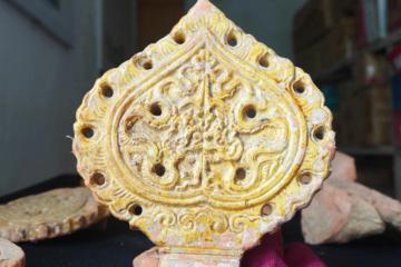A dragon design on a Bodhi leaf made of terracotta and glazed with gold was discovered at the Ho Dynasty Citadel World Heritage site.