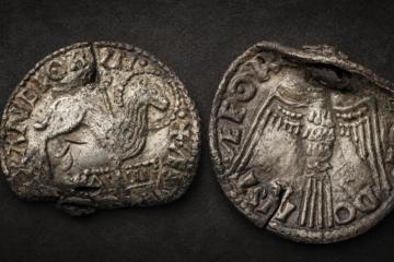 Obverse and reverse of the rare Anglo-Saxon Agnus Dei coin: the front shows the Lamb of God pierced by a cross and standing above the Alpha and Omega, while the reverse features the Holy Spirit dove.