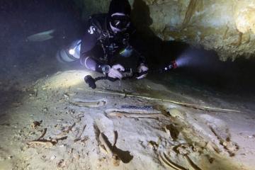 Underwater archaeologist Octavio del Río photographs the prehistoric skeleton discovered inside the flooded cave system in Actun, near Tulum, Mexico
