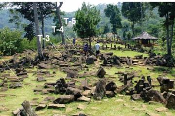 Grassy hilltop terrace scattered with dark columnar andesite blocks, with labels T-2 to T-5