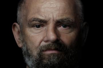 Digital reconstruction of a middle-aged man with close-cropped graying hair and a graying beard