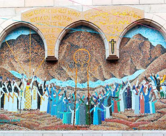 Mosaic representing Jesus Christ at the entrance of a small Coptic church with a wooden column porch in the Christian quarter of Cairo ( peizais/ Adobe Stock)