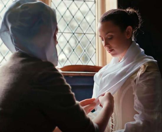 17th Century Woman Being Dressed. Source: YouTube Screenshot / CrowsEyeProductions