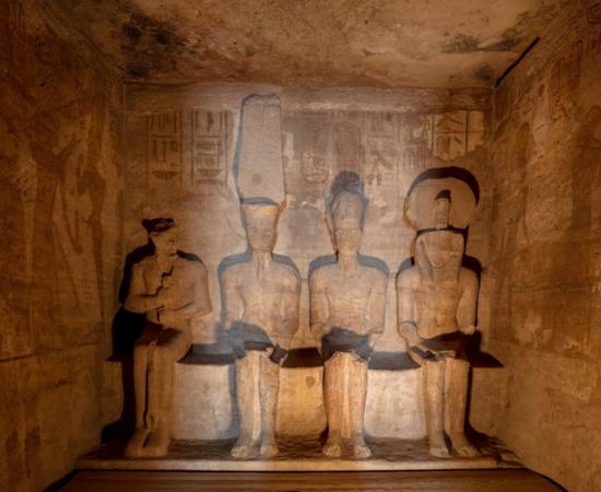 Sunlit statues in the inner sanctuary of the Great Temple at Abu Simbel.