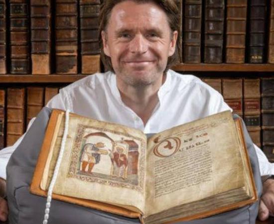 Professor David Woodman with the portrait of Æthelstan at The Parker Library, Corpus Christi College, Cambridge