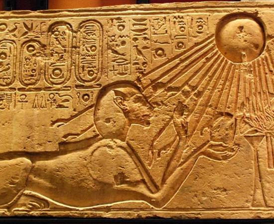 Akhenaten depicted as a sphinx at Amarna, solar rays bathing him.