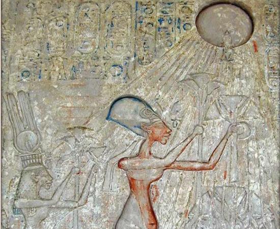 Pharaoh Akhenaten in the center and his family worshiping Aten personified as the rays of a solar disk; later such imagery was prohibited.		Source: Egyptian Museum / Public domain