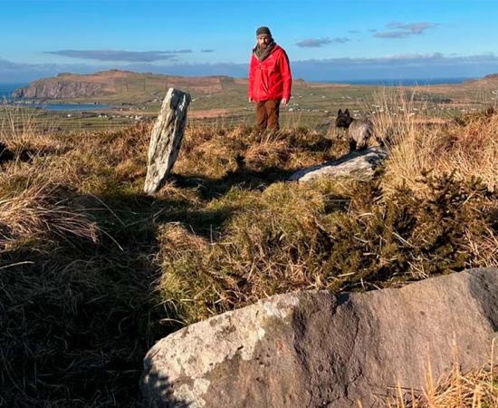 Billy Mag Fhloinn with the remnants of the wedge tomb, Altóir na Gréine, in County Kerry, Ireland. Source: Seán Mac an tSíthigh/RTÉ News