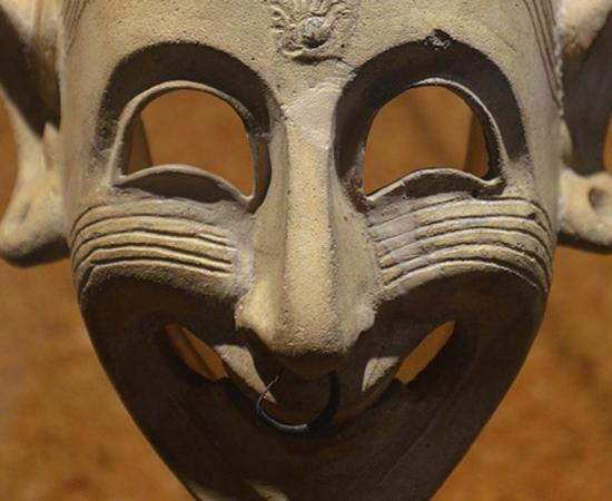 Detail of a Phoenician grinning mask, 4th century BC, found in a grave at San Sperate, Cagliari, Museo Archeologico Nazionale. 