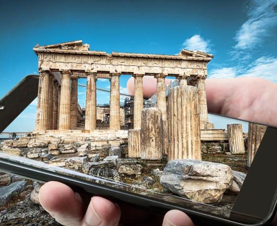 Ancient Greek science and technology represented by a 3D image of Athens landmark the Parthenon emerging from a smartphone screen.		Source: scaliger