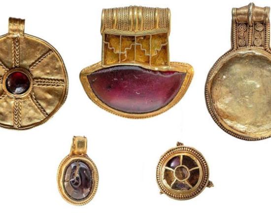 Four gold pendants and a gold-and-garnet brooch from the seventh century discovered in Lincolnshire, England
